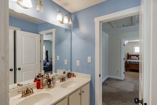 full bath featuring a sink, double vanity, connected bathroom, and baseboards