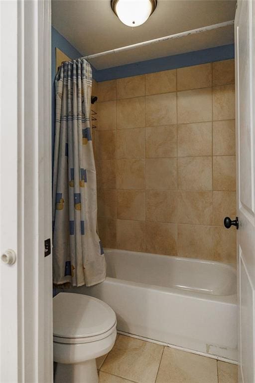 full bathroom with shower / bath combination with curtain, toilet, and tile patterned floors