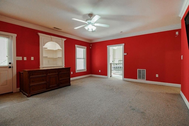 unfurnished room featuring visible vents, crown molding, light carpet, and baseboards