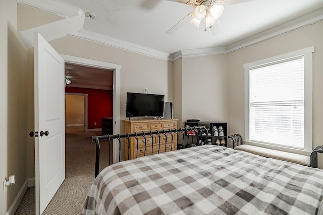 bedroom featuring carpet floors, baseboards, ornamental molding, and a ceiling fan