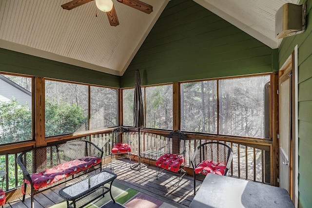 unfurnished sunroom featuring lofted ceiling, a healthy amount of sunlight, and ceiling fan