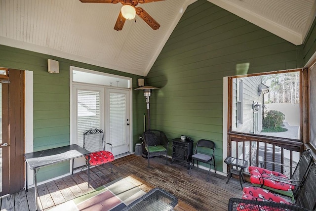 sunroom / solarium featuring lofted ceiling and ceiling fan