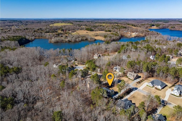 drone / aerial view featuring a water view and a forest view