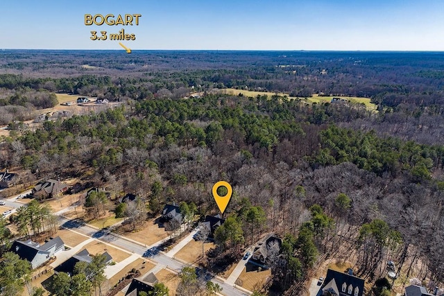 aerial view featuring a wooded view