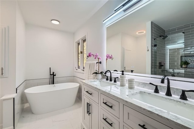 bathroom featuring vanity and separate shower and tub