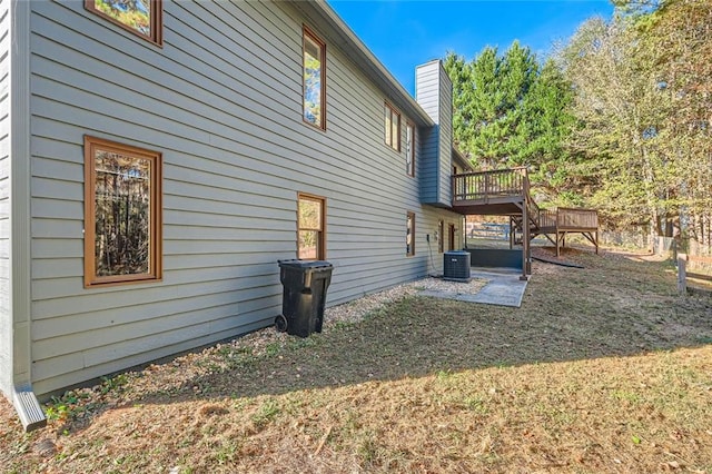 rear view of property with a patio area and a wooden deck