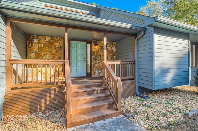 view of exterior entry with a porch