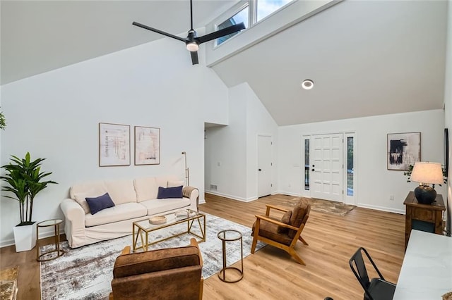 living room featuring hardwood / wood-style flooring, ceiling fan, and high vaulted ceiling