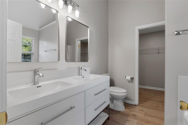 4625 Thermal Ct, Douglasville, GA 30135 - bathroom featuring a sink, double vanity, toilet, and wood finished floors
