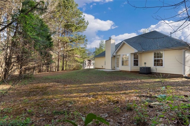 4625 Thermal Ct, Douglasville, GA 30135 - back of property featuring a shingled roof, a patio area, a chimney, and cooling unit