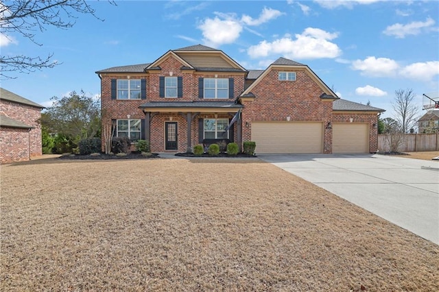 view of front facade with driveway, an attached garage, fence, and brick siding