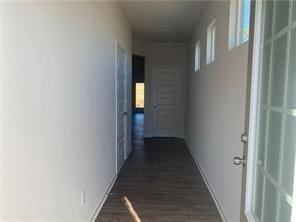 corridor with dark hardwood / wood-style flooring