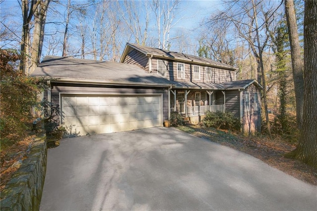 front facade with a garage and a porch