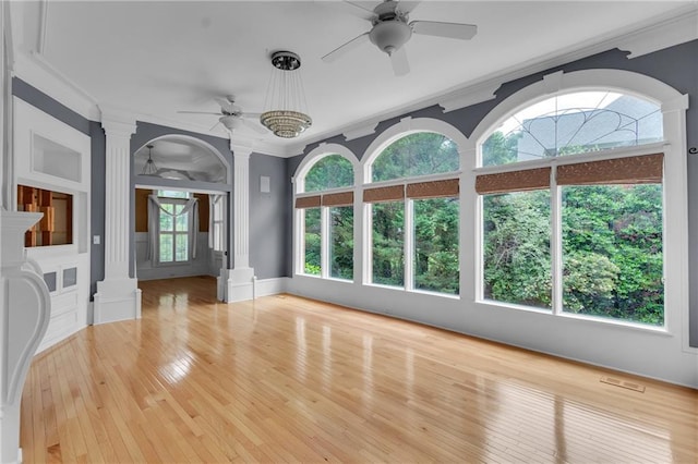 470 Manor Oak Ln SE, Marietta, GA 30067 - unfurnished living room featuring ornate columns, ceiling fan, crown molding, hardwood / wood-style flooring, and baseboards