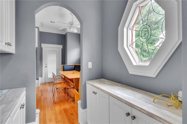 470 Manor Oak Ln SE, Marietta, GA 30067 - interior space with white cabinetry, light wood-style floors, arched walkways, ceiling fan, and an office area