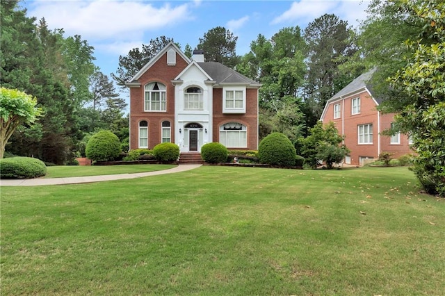 470 Manor Oak Ln SE, Marietta, GA 30067 - colonial house with a front yard, a chimney, and brick siding