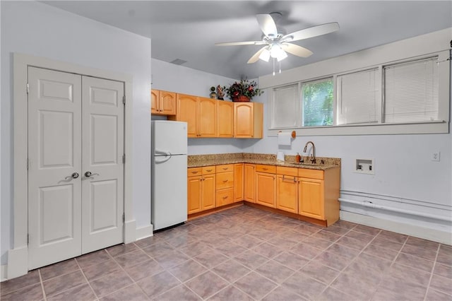 470 Manor Oak Ln SE, Marietta, GA 30067 - kitchen with freestanding refrigerator, a sink, a ceiling fan, light stone countertops, and light brown cabinets