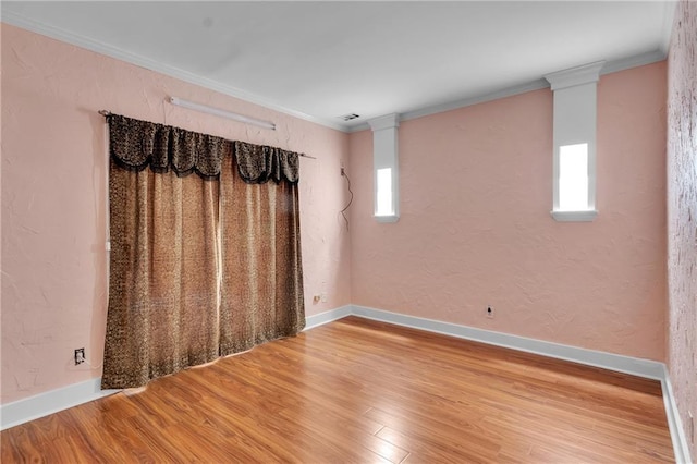 470 Manor Oak Ln SE, Marietta, GA 30067 - empty room featuring wood finished floors, healthy amount of natural light, crown molding, baseboards, and a textured wall
