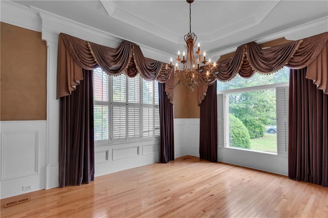 470 Manor Oak Ln SE, Marietta, GA 30067 - spare room featuring a chandelier, light wood-type flooring, a decorative wall, a wainscoted wall, and crown molding