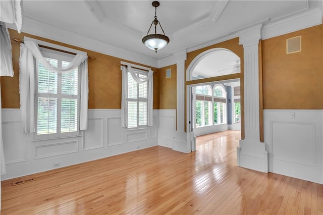 470 Manor Oak Ln SE, Marietta, GA 30067 - spare room featuring decorative columns, wainscoting, a decorative wall, light wood-style flooring, and crown molding
