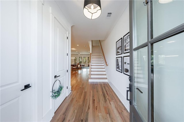 corridor with light hardwood / wood-style flooring