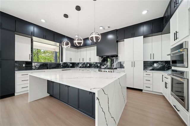 155 Westbrook St, Buford, GA 30518 - kitchen featuring tasteful backsplash, hanging light fixtures, a large island, and light stone counters