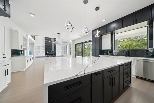 155 Westbrook St, Buford, GA 30518 - kitchen featuring a large island, a sink, open floor plan, dark cabinetry, and stainless steel dishwasher