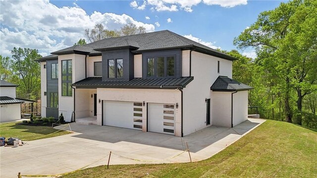 155 Westbrook St, Buford, GA 30518 - view of front of property featuring an attached garage, a standing seam roof, stucco siding, and metal roof