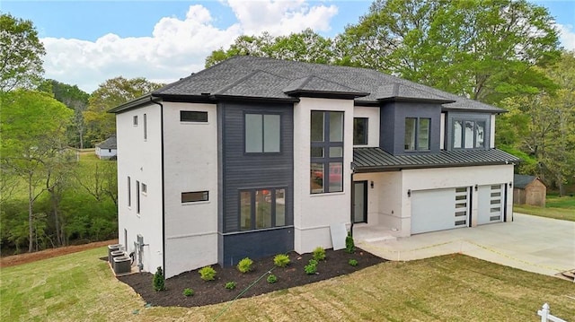 155 Westbrook St, Buford, GA 30518 - view of front of home with a standing seam roof, a garage, stucco siding, metal roof, and driveway