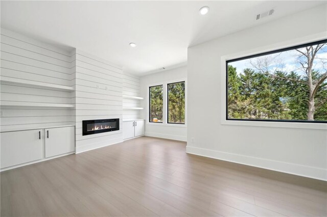 155 Westbrook St, Buford, GA 30518 - unfurnished living room with a large fireplace, visible vents, recessed lighting, wood finished floors, and baseboards