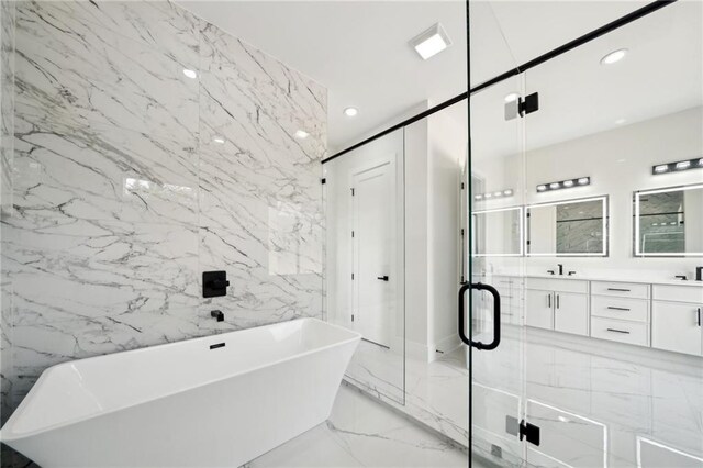 155 Westbrook St, Buford, GA 30518 - bathroom featuring stone wall, marble finish floor, a soaking tub, and recessed lighting