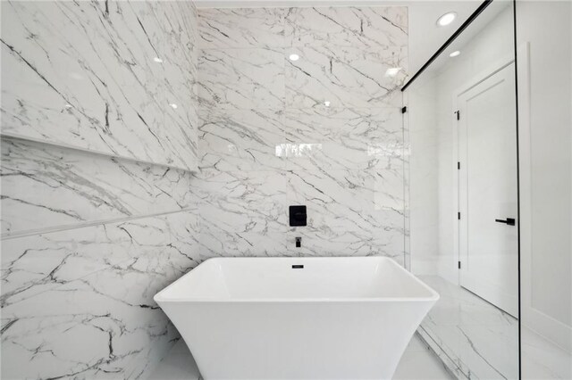 155 Westbrook St, Buford, GA 30518 - full bath with a freestanding bath, stone wall, marble finish floor, and recessed lighting