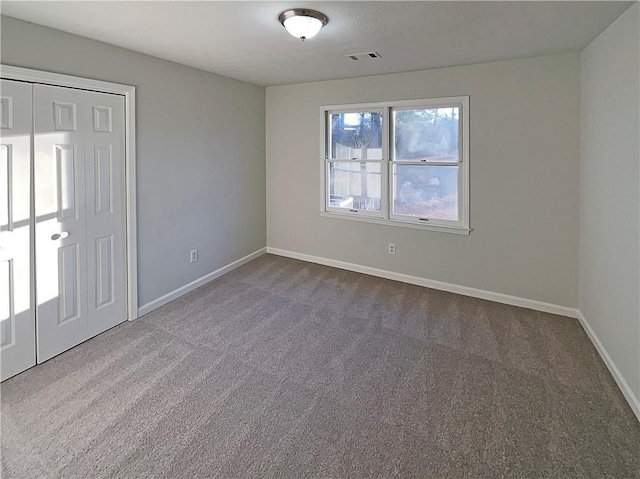 unfurnished bedroom featuring carpet floors and a closet