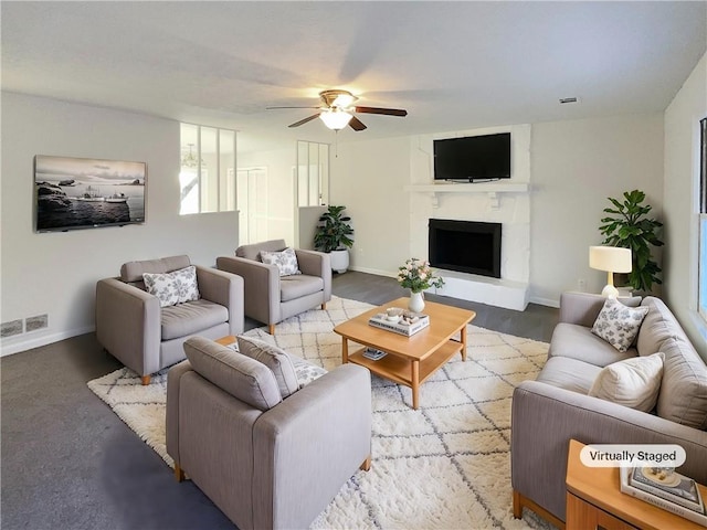 living room with a large fireplace and ceiling fan