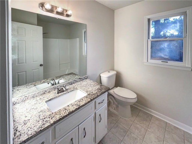 bathroom featuring tile patterned flooring, vanity, a shower, and toilet