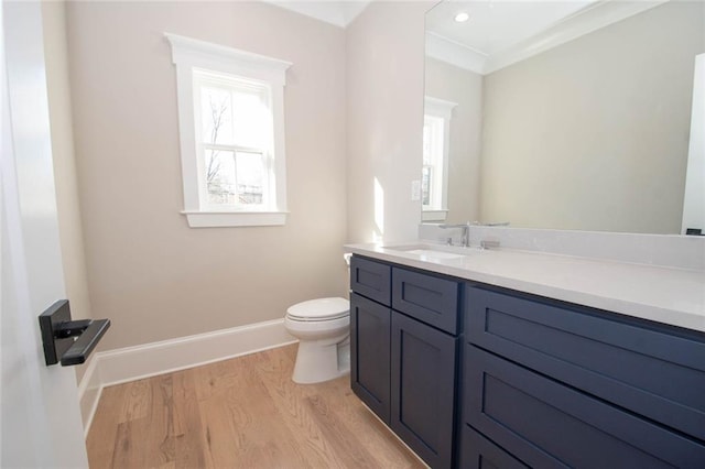 bathroom featuring hardwood / wood-style floors, vanity, toilet, and crown molding