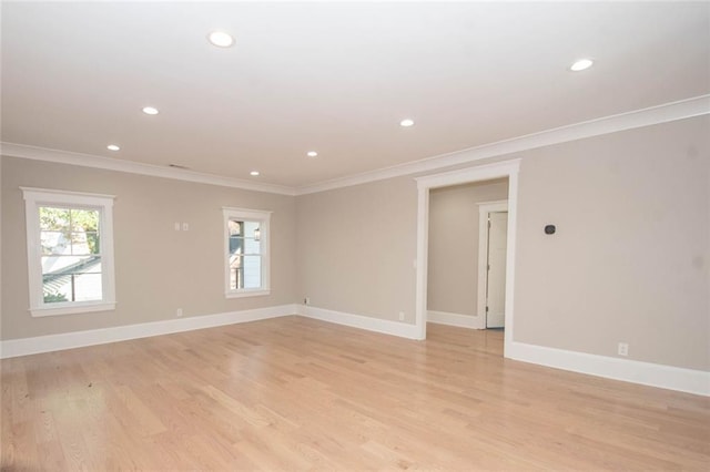 spare room with light wood-type flooring and ornamental molding