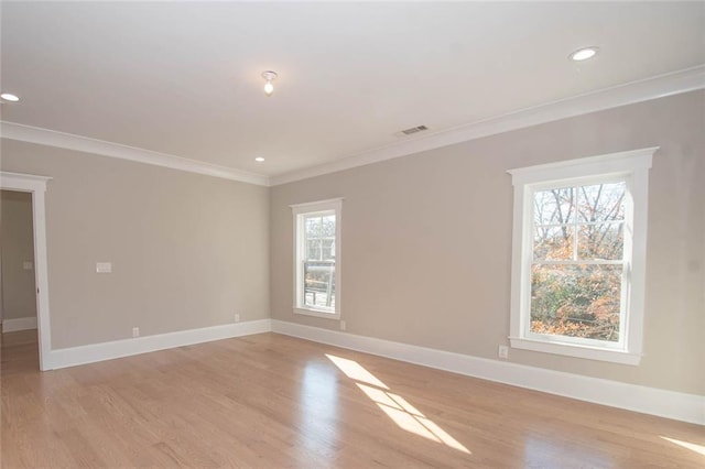 unfurnished room featuring light hardwood / wood-style floors and ornamental molding