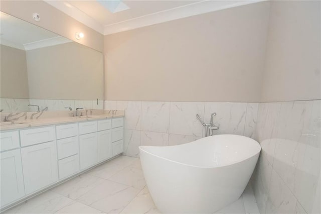 bathroom with vanity, ornamental molding, a tub to relax in, and tile walls