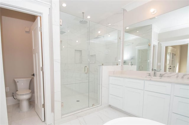 bathroom featuring vanity, toilet, and an enclosed shower