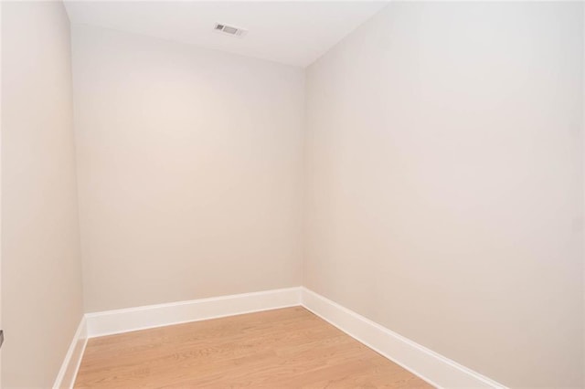 empty room with light hardwood / wood-style flooring