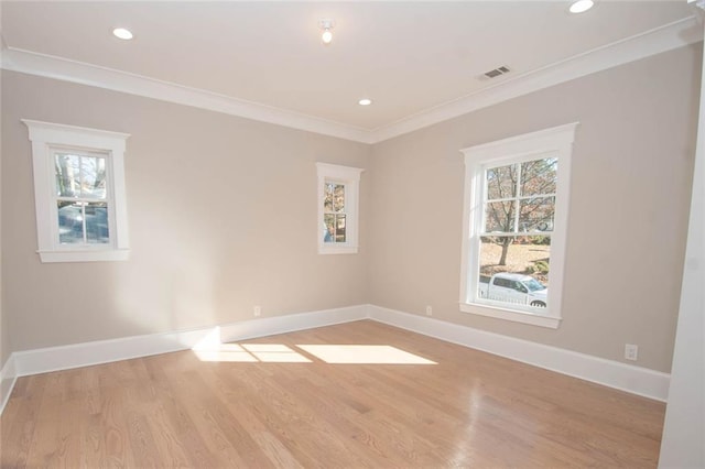 unfurnished room featuring light hardwood / wood-style floors and crown molding