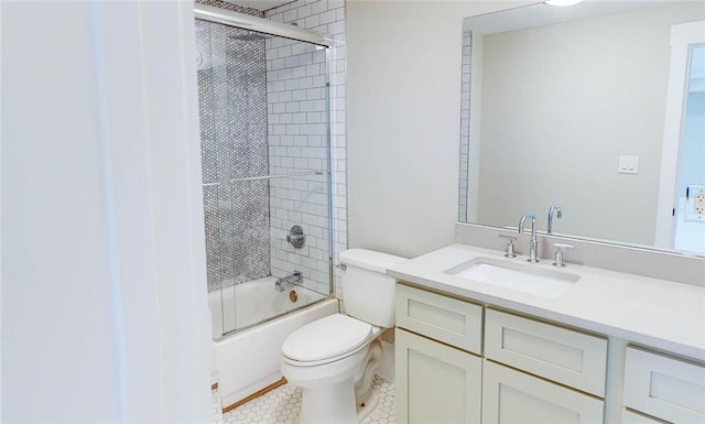 full bathroom featuring tile patterned floors, vanity, toilet, and shower / bath combination with glass door