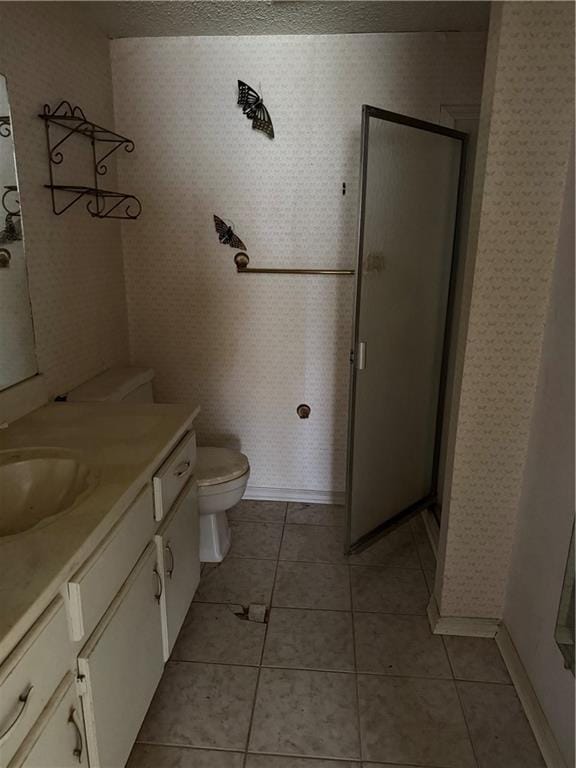 809 Camelot Dr, College Park, GA 30349 - full bath with vanity, a stall shower, toilet, tile patterned floors, and wallpapered walls