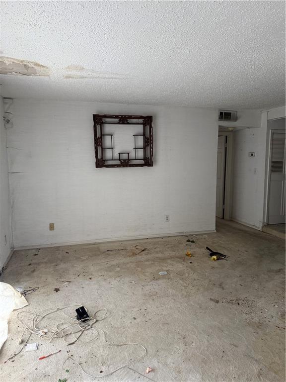 809 Camelot Dr, College Park, GA 30349 - empty room with a textured ceiling