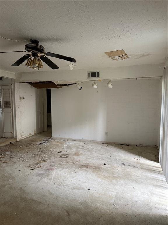 809 Camelot Dr, College Park, GA 30349 - empty room with a textured ceiling and ceiling fan