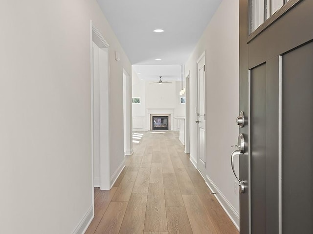 corridor with light hardwood / wood-style floors