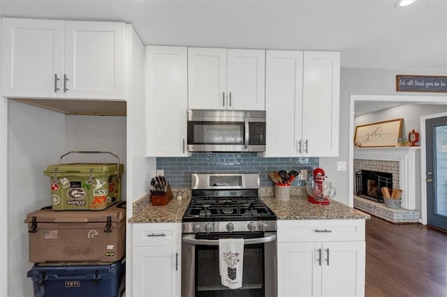 70 Maplewood Ln, Acworth, GA 30101 - kitchen with appliances with stainless steel finishes, stone counters, white cabinets, and decorative backsplash