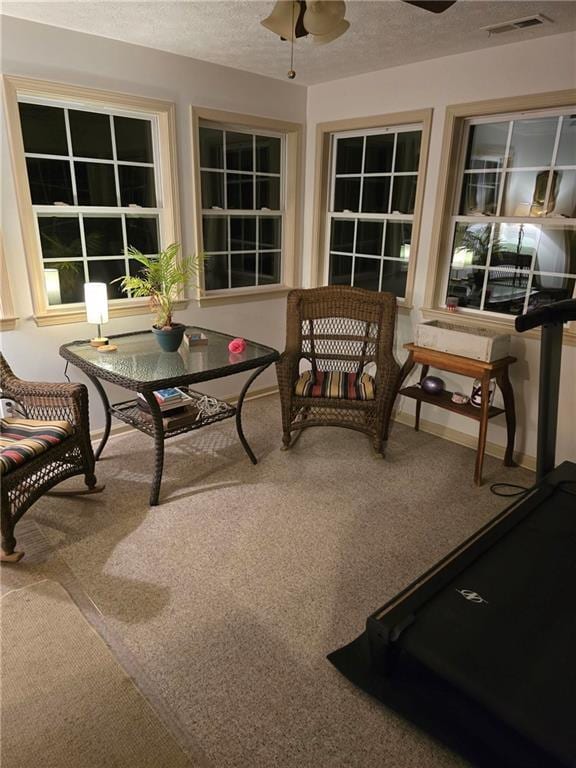 sunroom / solarium featuring ceiling fan