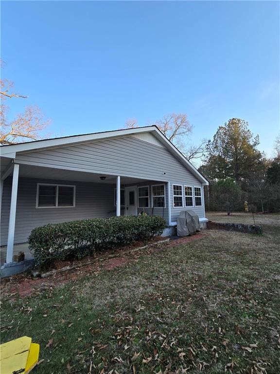 rear view of property with a lawn